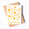 A greeting card with seven sunny side up eggs drawn in yellow ink and the phrase "so egg-cited for you!"