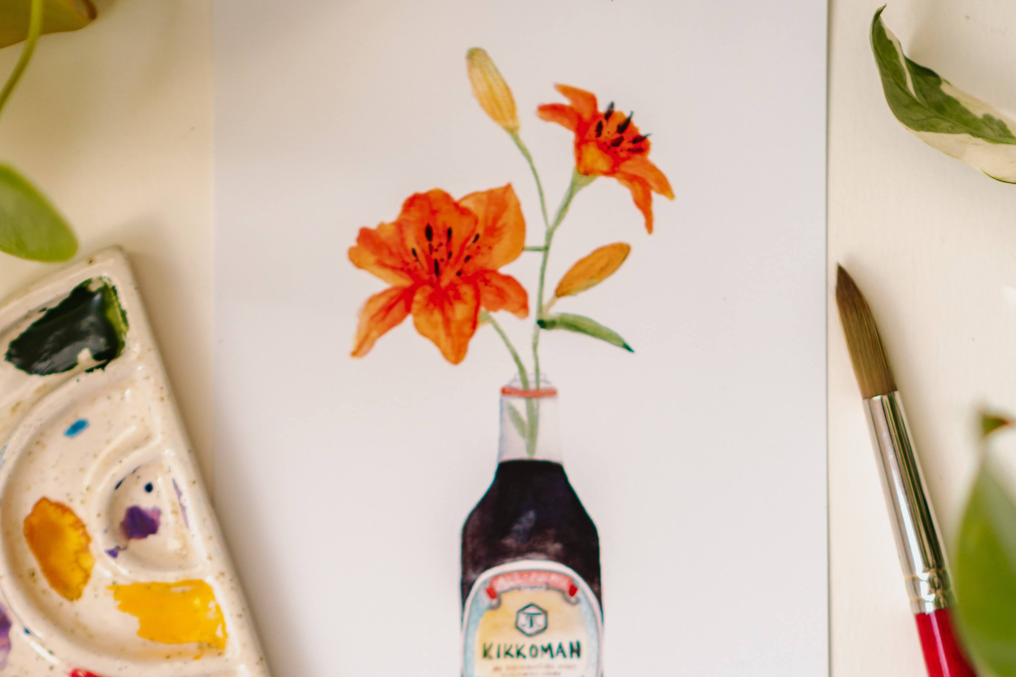A watercolor art print of two orange tiger lilies in a Kikkoman soy sauce bottle.