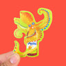A sticker of a yellow, smilng squid wrapped around the top of a Squid brand fish sauce bottle. The background of the sticker is light green and matches the bottle label.
