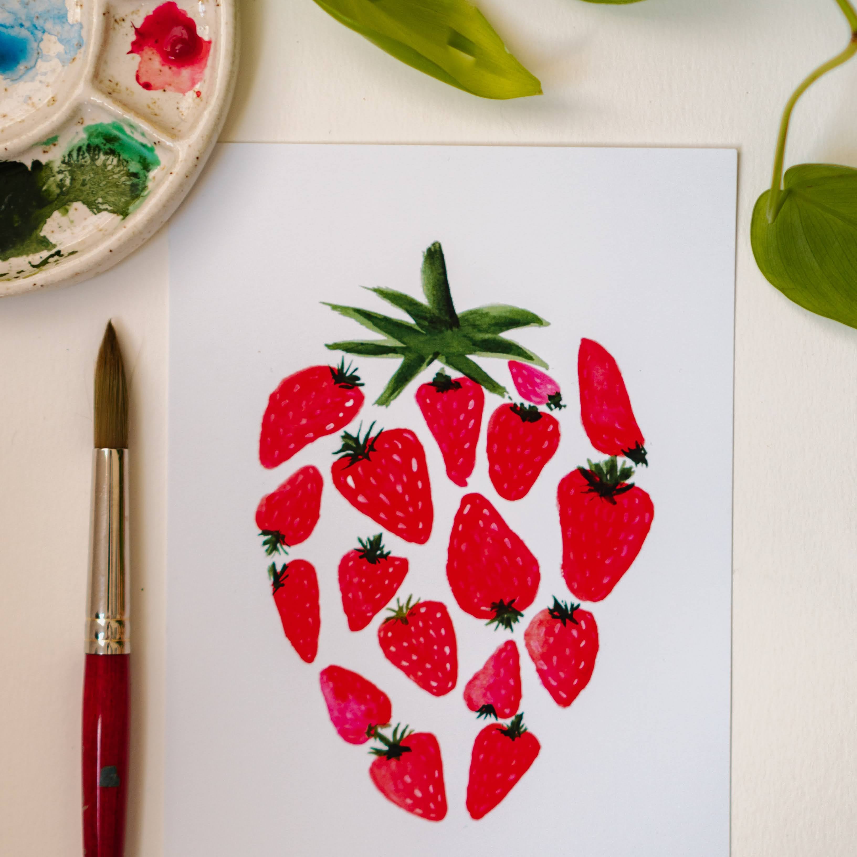 A watercolor print of several smaller, red strawberries making up one large strawberry.