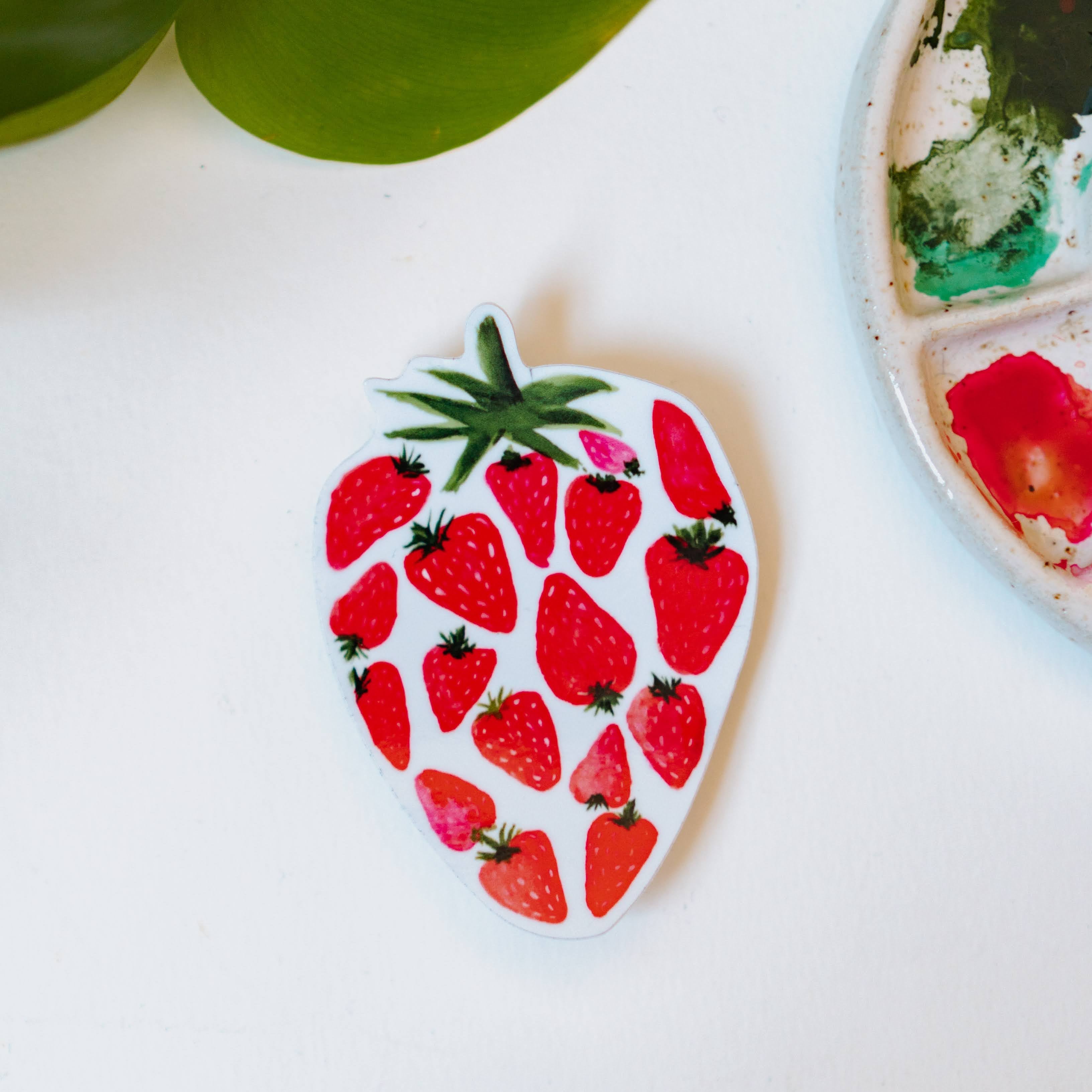 A watercolor sticker of several smaller, red strawberries making up one large strawberry.