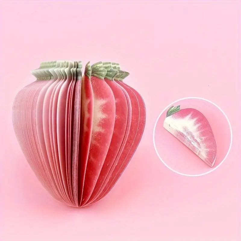 Strawberry-shaped notebook with a close-up inset on a pink background