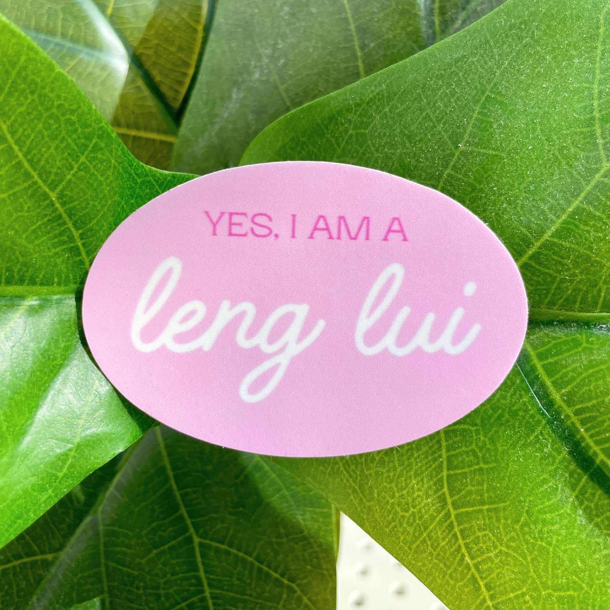 A light pink sticker with the words "Yes, I am a leng lui" written on it.