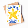 A greeting card featuring smiling yellow watercolor stars. "You're a star!" is written across the card in dark blue letters.