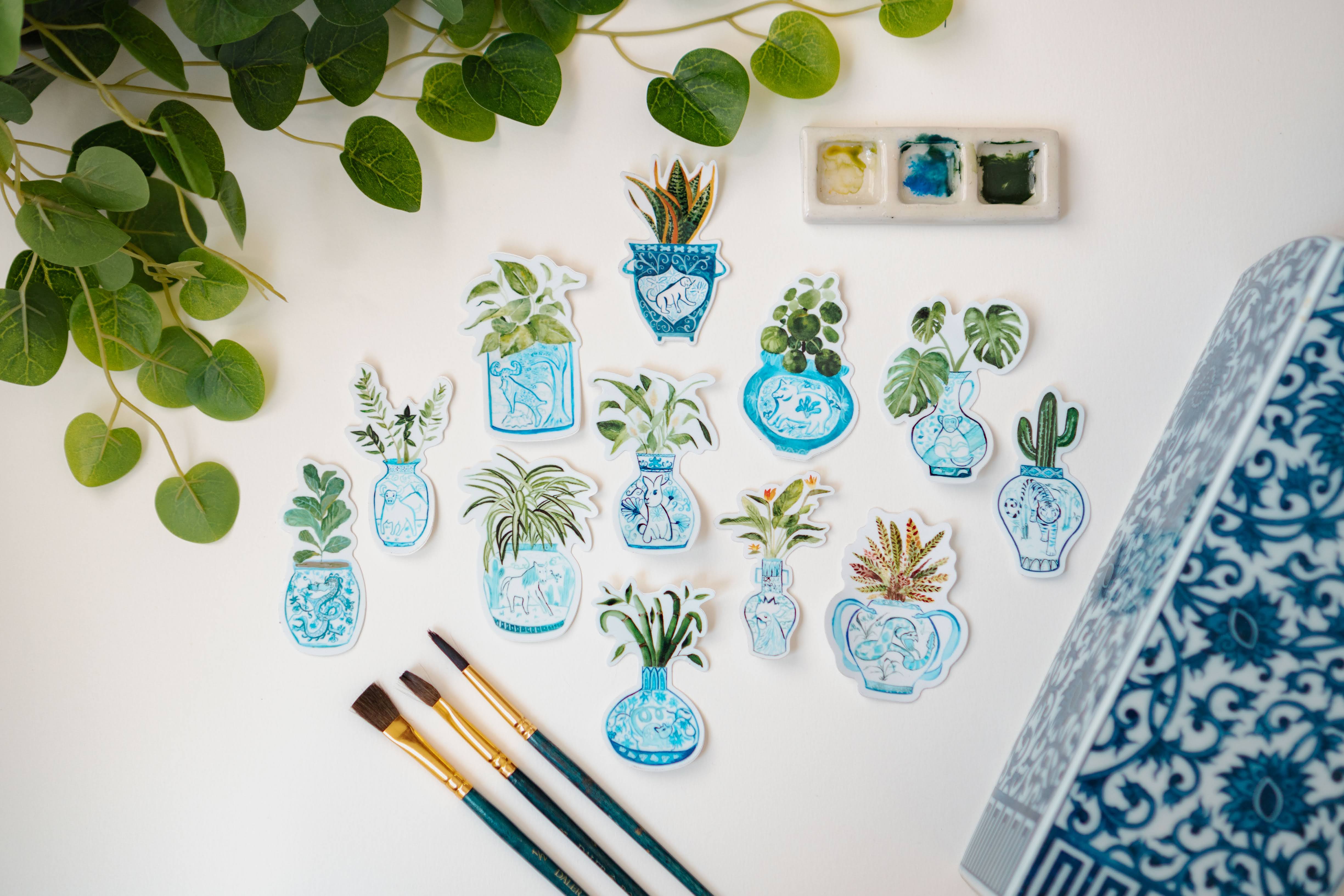 A collection of Menmin Made's Zodiac Plant Stickers, including the Year of the Dragon + Fiddle-Leaf Fig Sticker.