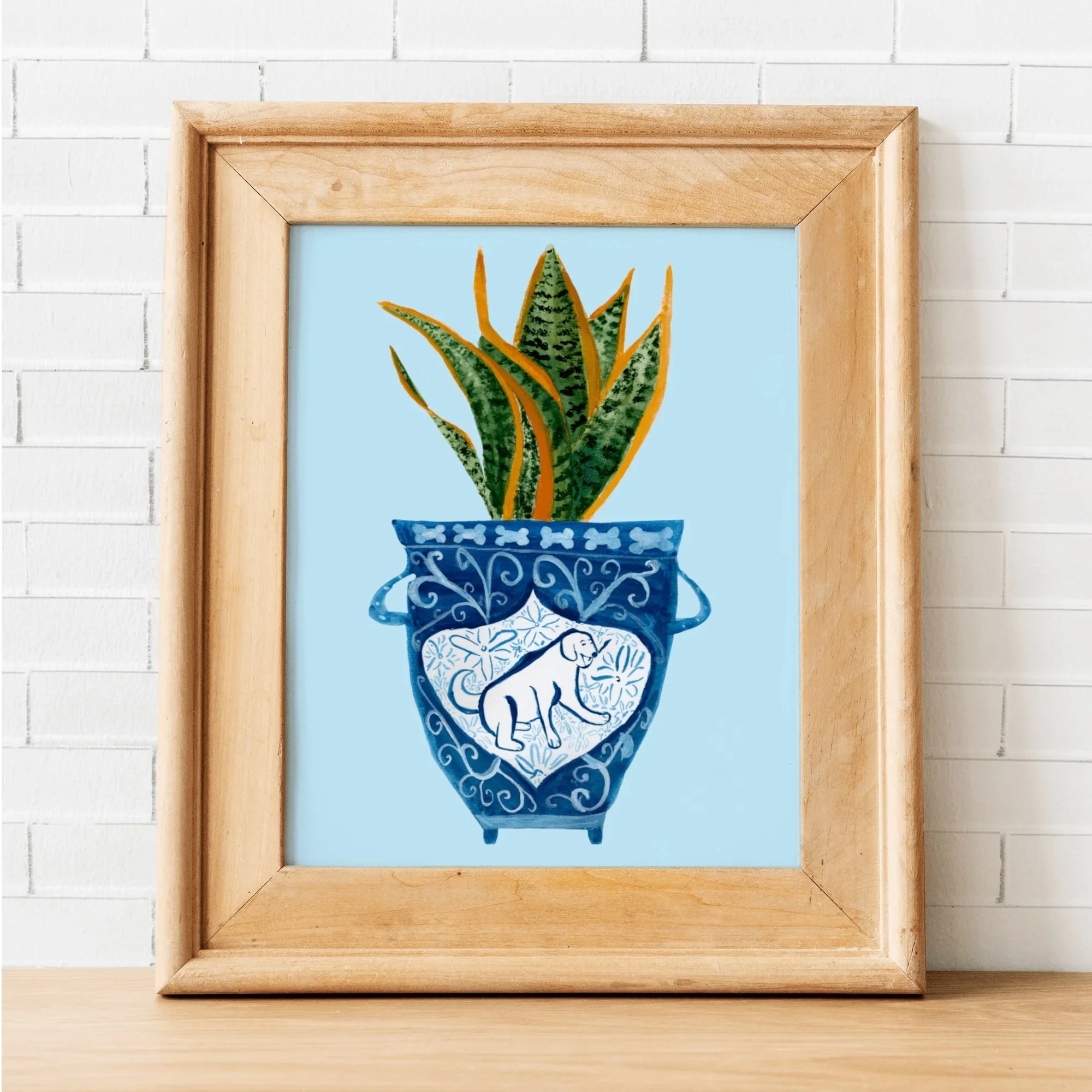 Framed art print of snake plant in blue patterned pot with dog design, whimsical home decor