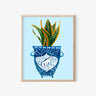 Whimsical blue vase with dog design holding a snake plant, AAPI-inspired home decor