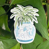 A sticker of a spider plant in a blue and white porcelain vase, decorated with a horse.