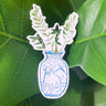 A sticker of a ZZ plant in a blue and white porcelain vase, decorated with an ox.