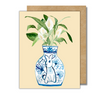 A greeting card featuring a peace lily plant in a blue and white porcelain vase, decorated with a rabbit.