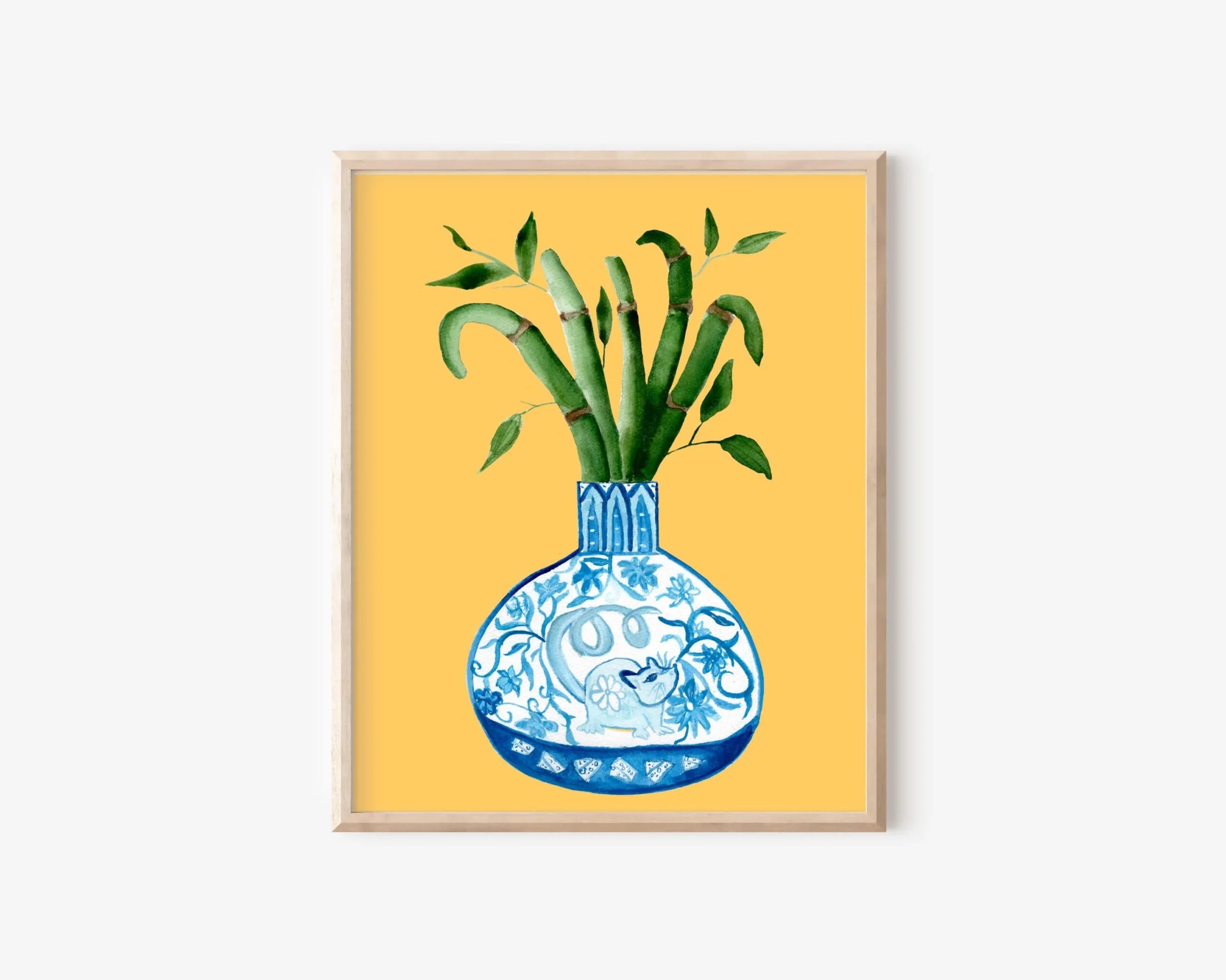 Framed art print of blue and white vase with bamboo, AAPI-inspired home decor on yellow background