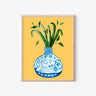 Framed art print of blue and white vase with bamboo, AAPI-inspired home decor on yellow background