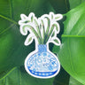 A sticker of a bamboo plant in a blue and white porcelain vase, decorated with a rat.