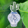 A sticker of a saguaro cactus in a blue and white porcelain vase, decorated with a tiger.